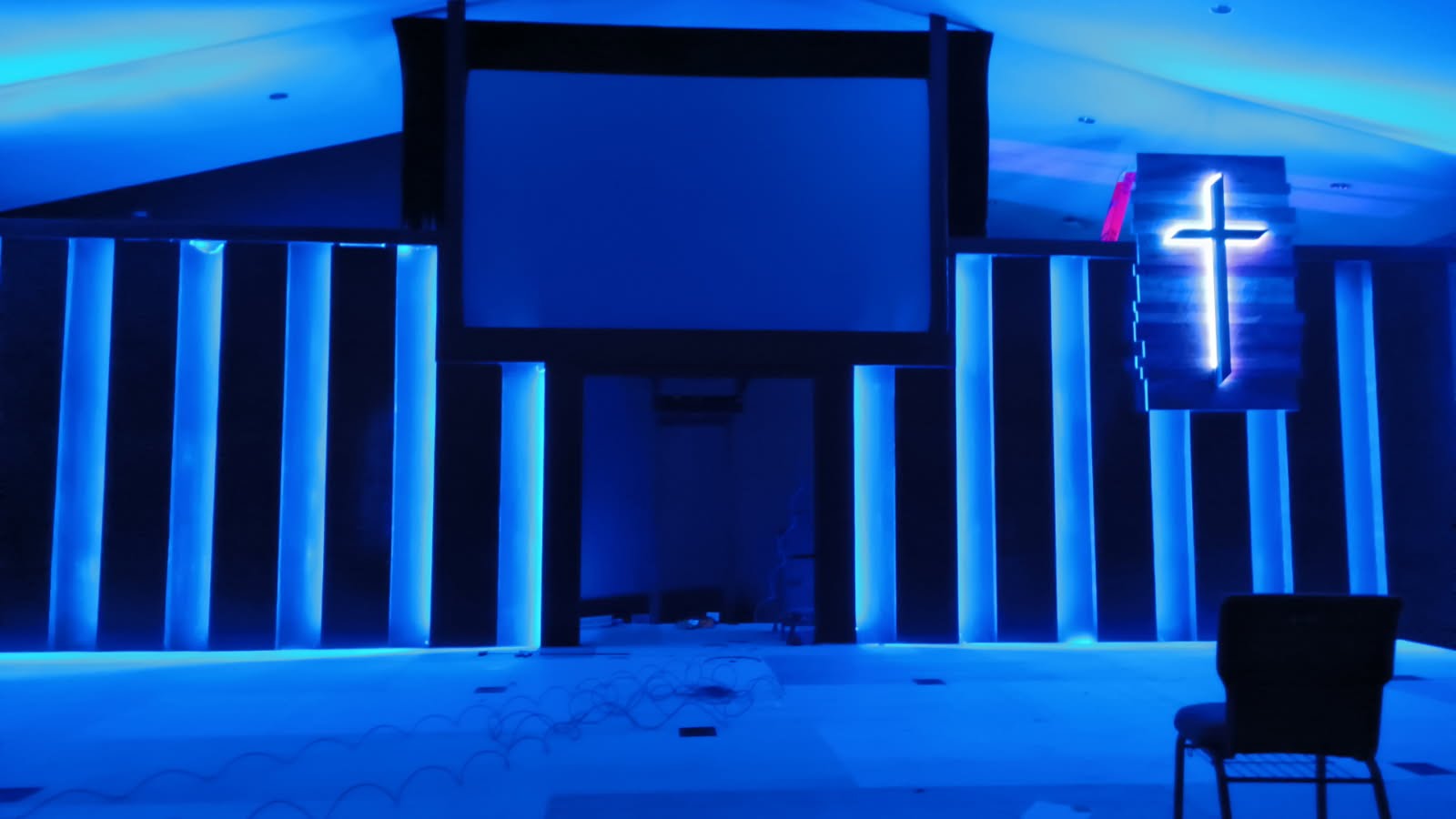 CenterPoint Church — stage in a blue wash with the illuminated cross