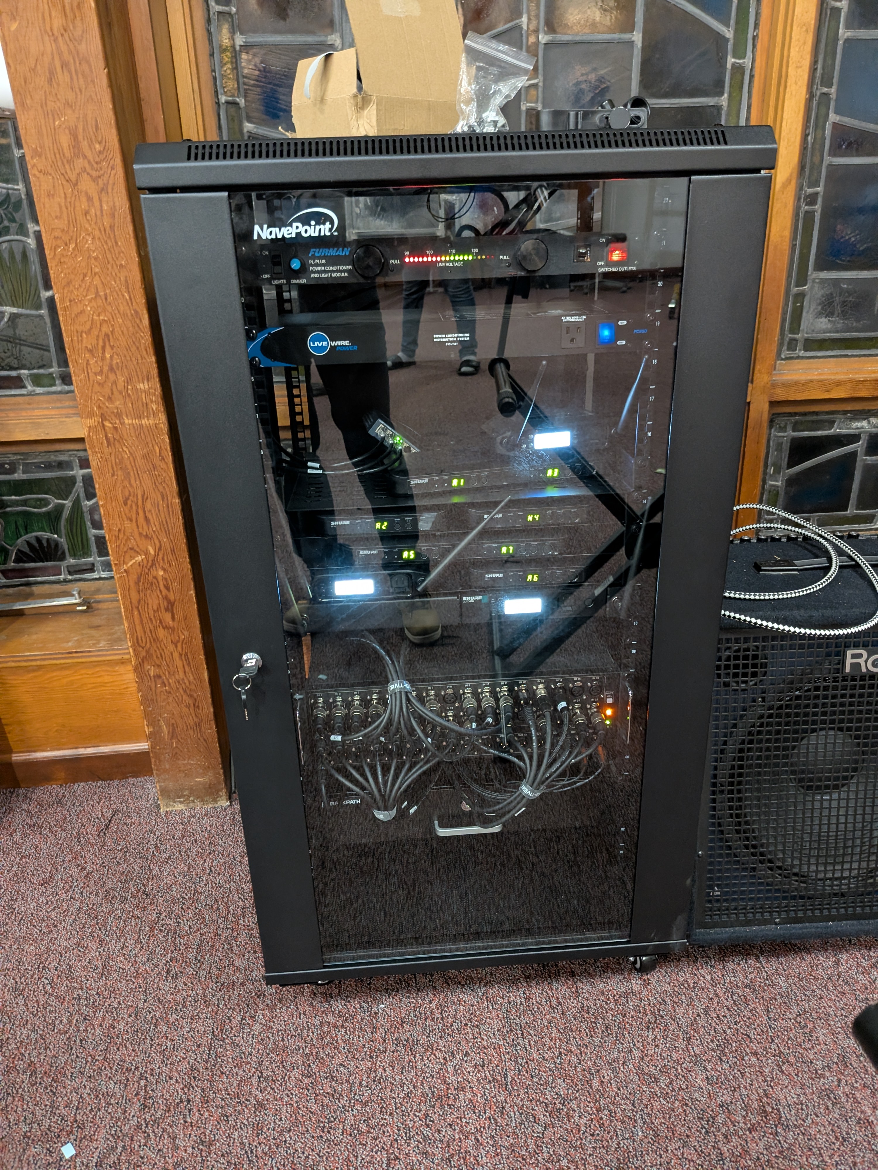 After — new 22U NavePoint wall-mount rack with locking glass door and clean cable management