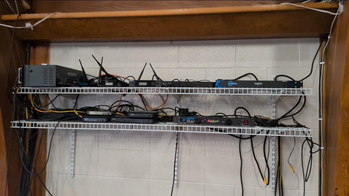 Before — open wire shelf with tangled cables and exposed equipment