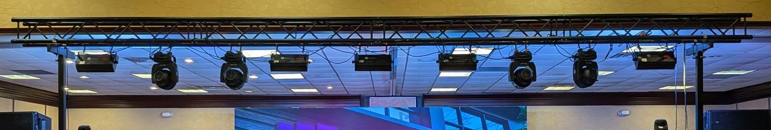 Tech in Church truss rig with moving head and beam fixtures